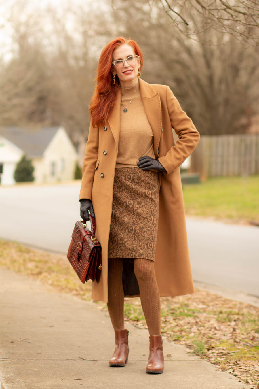 women's camel coat and neutral outfit