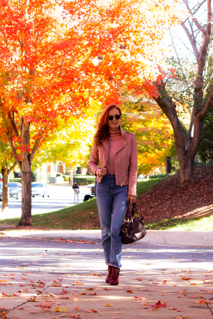 Pink moto jacket with jeans and plum accessories