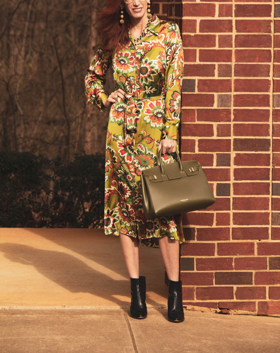 Wearing bright colors in the winter- green print dress with neutral accessories