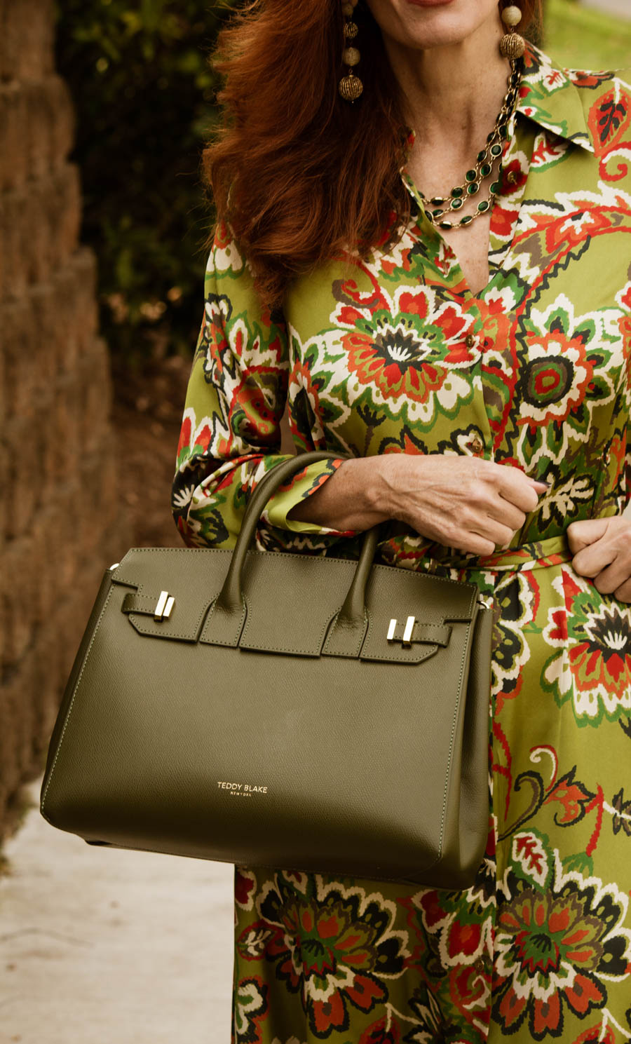 Wearing bright colors in the winter- green print dress with neutral accessories