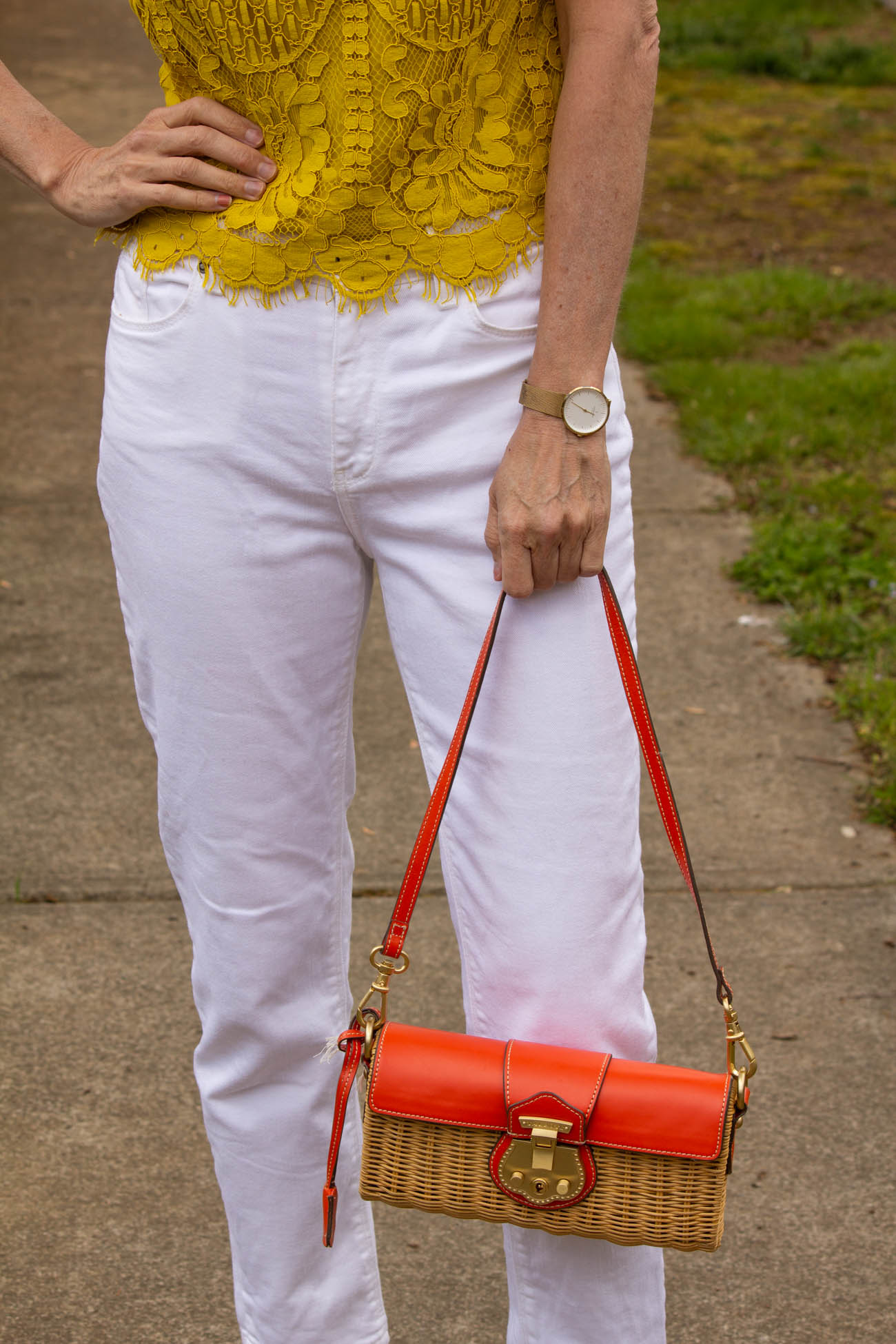 Yellow lace top, white jeans and orange rattan bag